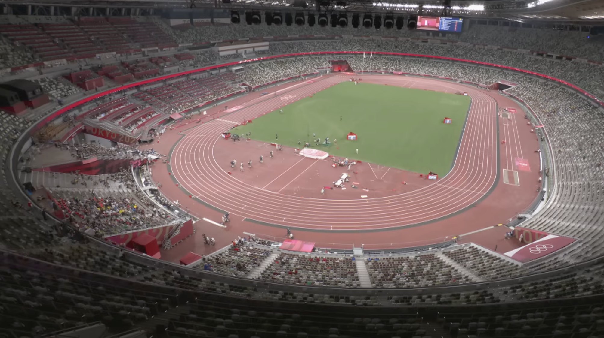 The 68,000-seat Tokyo 2020 Olympic Stadium seen from above, nearly empty of spectators.