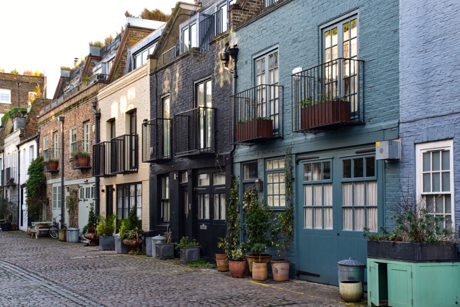 A cobbled lane lined with small painted houses.